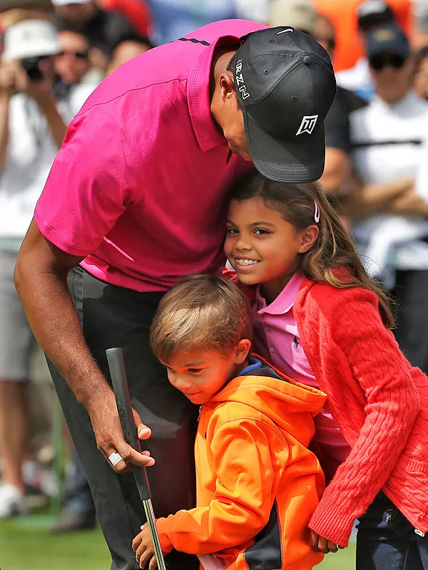 Tiger Woods shares touching, heartfelt reflections on the profound bond he has with his children, Charlie and Sam, as seen in a heartwarming family photograph.