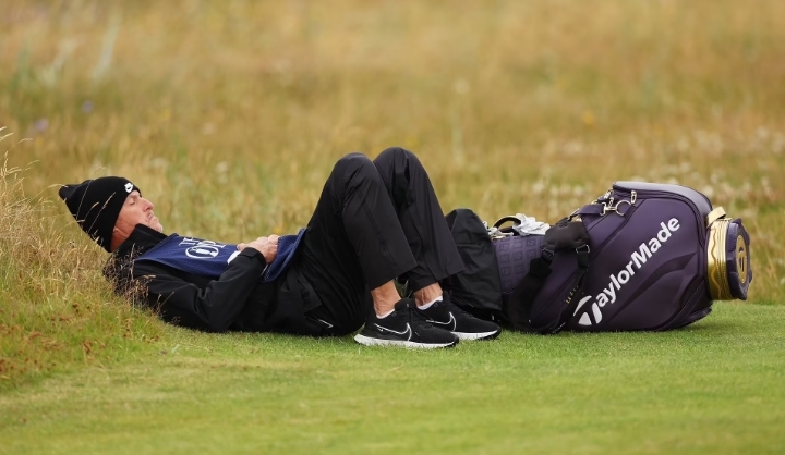 Scottie Scheffler’s caddie gets ‘really sick’ at The Open as he’s forced to lie down on the ground while soldiering on through round two at Royal Troon