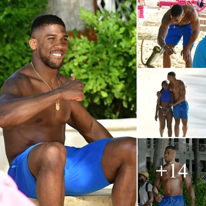 During a beach holiday in Barbados, Anthony Joshua was seen  putting his arm around an unknown woman…..